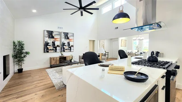 a kitchen with a table chairs and white cabinets