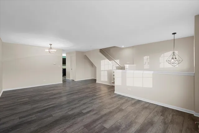 a view of a room with wooden floor and white walls