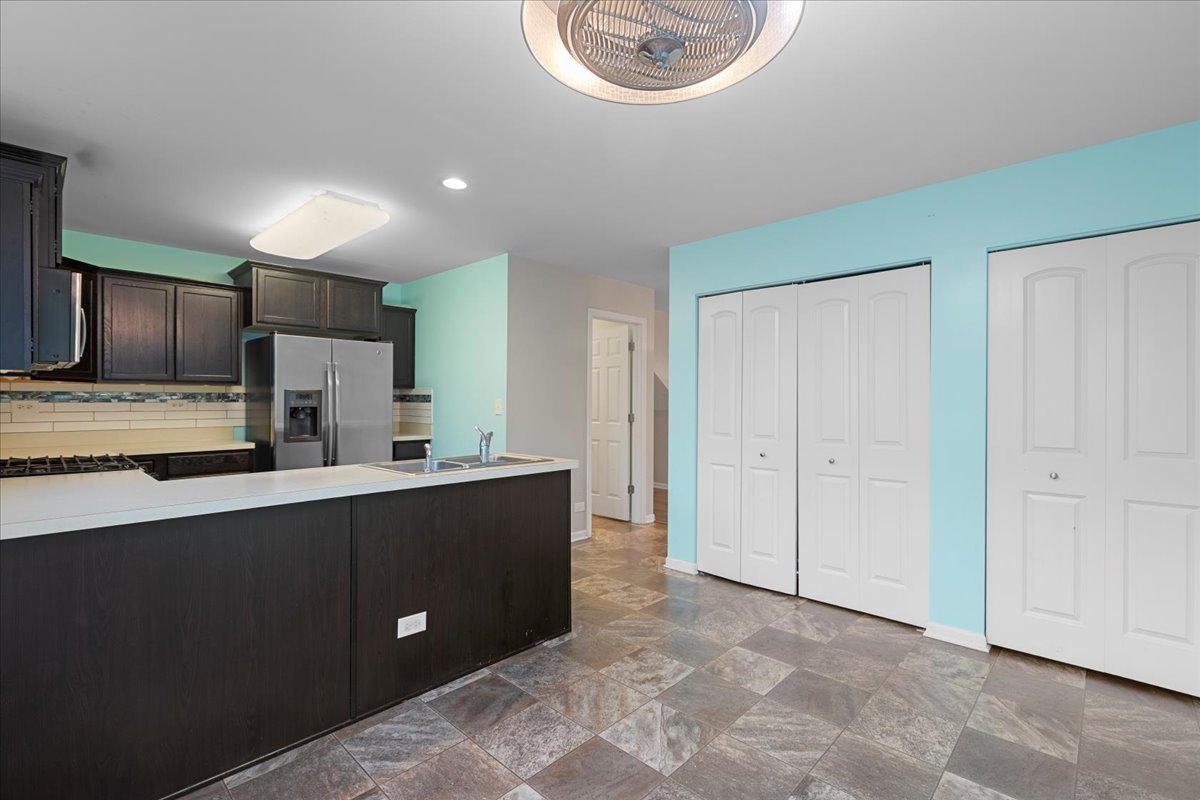 1092 Sapphire Lane Pingree Grove, IL 60140 - Photo 6 of 21 a kitchen with stainless steel appliances a sink a stove a refrigerator and cabinets