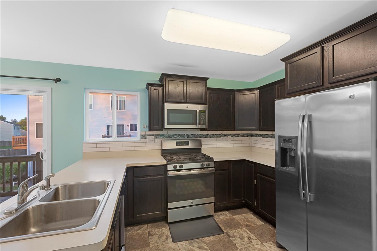 1092 Sapphire Lane Pingree Grove, IL 60140 - Photo 8 of 21 a kitchen with a refrigerator sink and stove