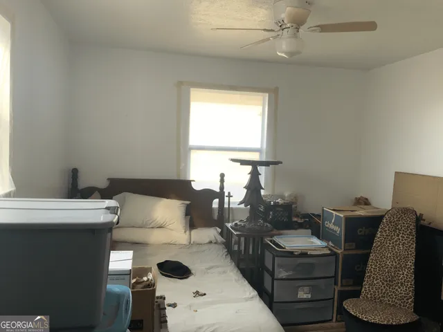 a living room with furniture a chandelier and a window