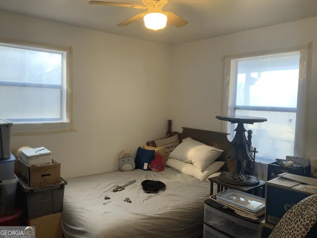 a view of a field of grass and trees