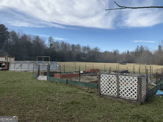 a view of a wooden fence and a yard