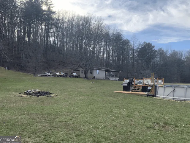a view of a backyard with swimming pool