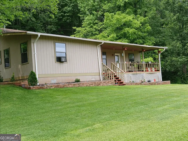 a view of a house with a yard and garage