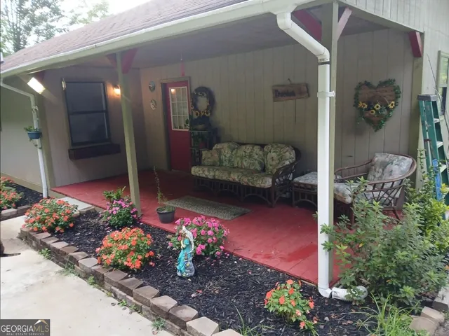 a front view of a house with a flower garden