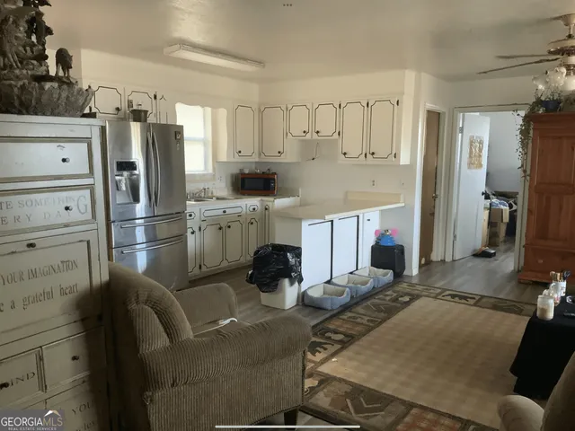 a bedroom with bed and wooden floor