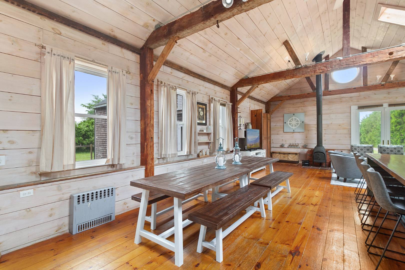 7 Town Line Road Wainscott, NY 11975 - Photo 11 of 17 a view of a patio with table and chairs and wooden floor