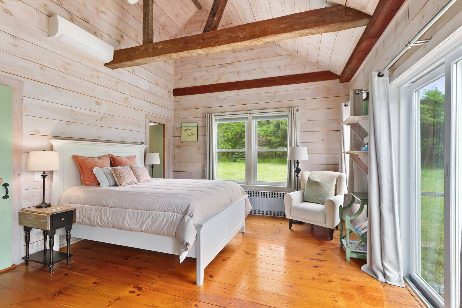 7 Town Line Road Wainscott, NY 11975 - Photo 8 of 17 a bedroom with a bed and large windows