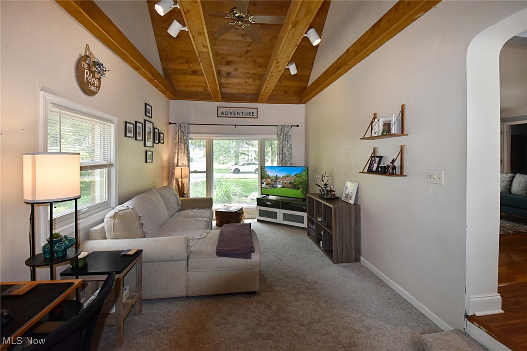 1388 Ford Road Lyndhurst, OH 44124 - Photo 13 of 39 Carpeted living room featuring lofted ceiling with beams, ceiling fan, and plenty of natural light