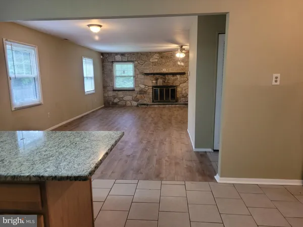 a view of kitchen with furniture and refrigerator