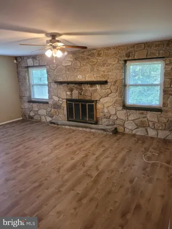 a view of a livingroom with wooden floor and a window
