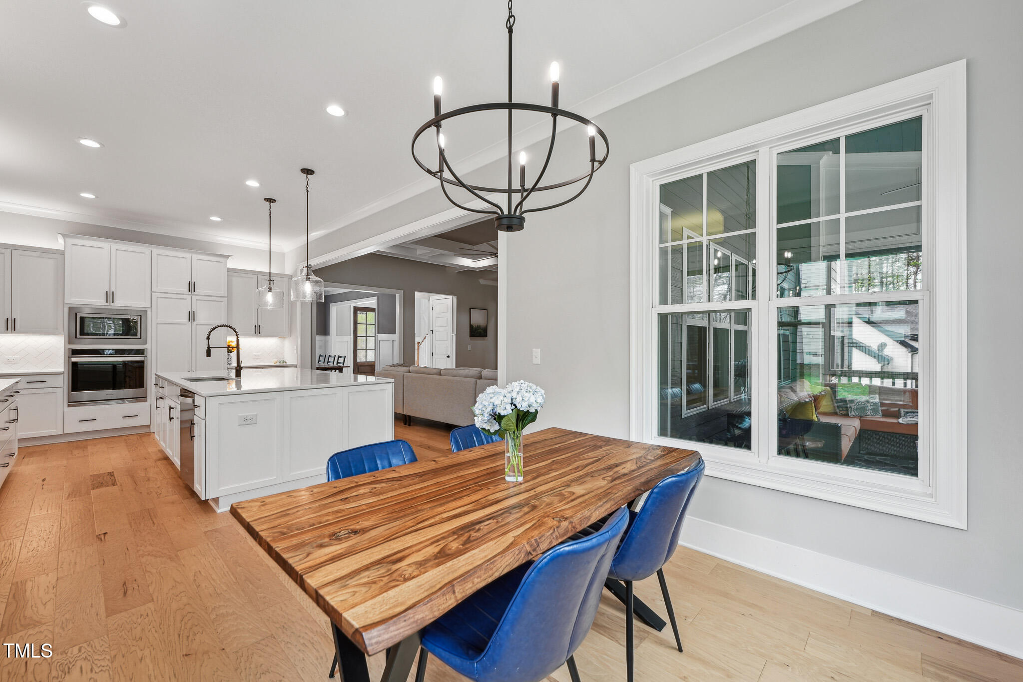 3545 Donlin Drive Wake Forest, NC 27587 - Photo 15 of 62 a kitchen with stainless steel appliances wooden floor dining table and chairs