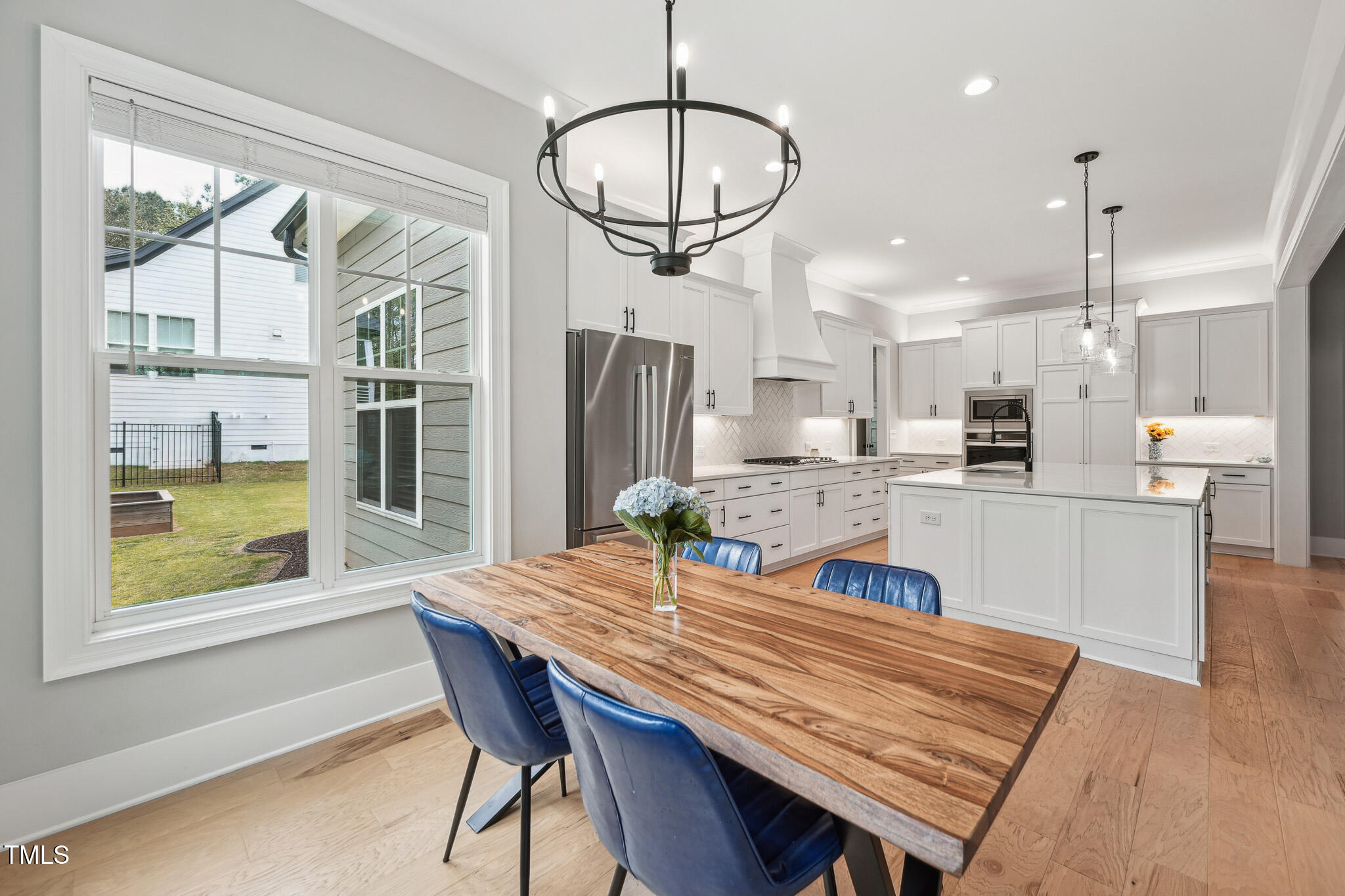 3545 Donlin Drive Wake Forest, NC 27587 - Photo 16 of 62 a view of a dining room and livingroom with furniture wooden floor a chandelier