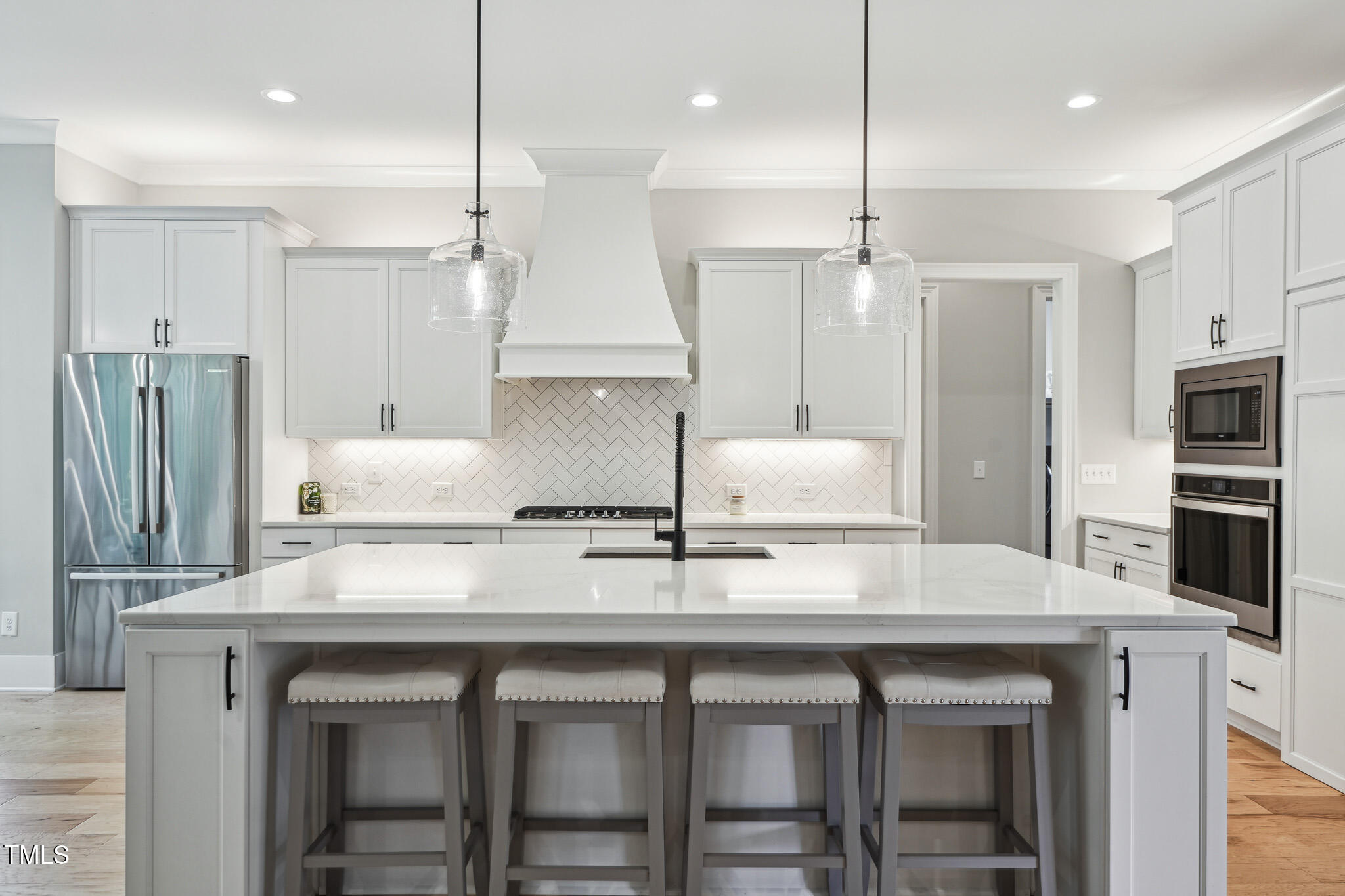3545 Donlin Drive Wake Forest, NC 27587 - Photo 22 of 62 a kitchen with granite countertop a table chairs stainless steel appliances and wooden floor