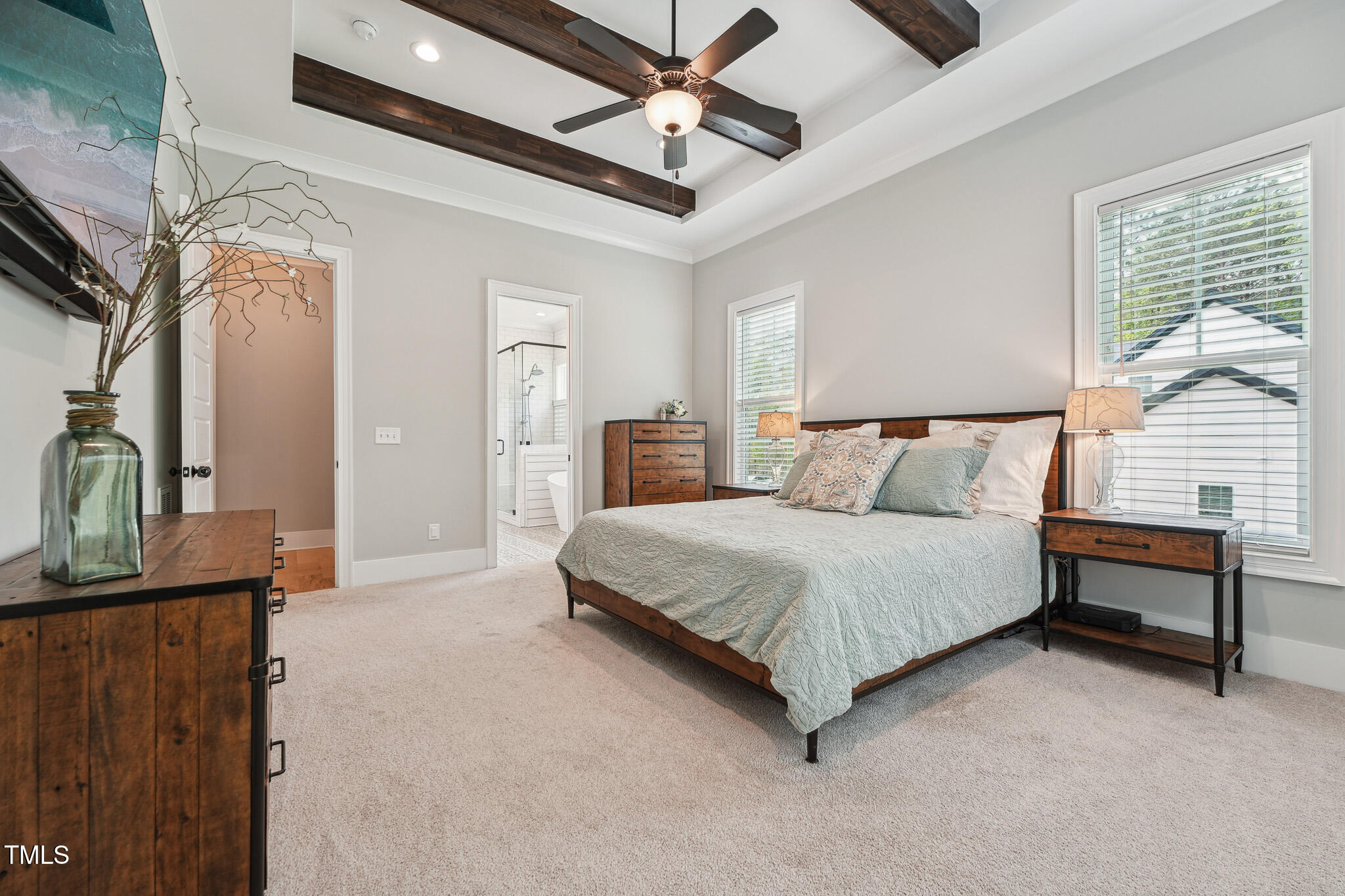 3545 Donlin Drive Wake Forest, NC 27587 - Photo 28 of 62 a spacious bedroom with a bed a dresser and a chandelier