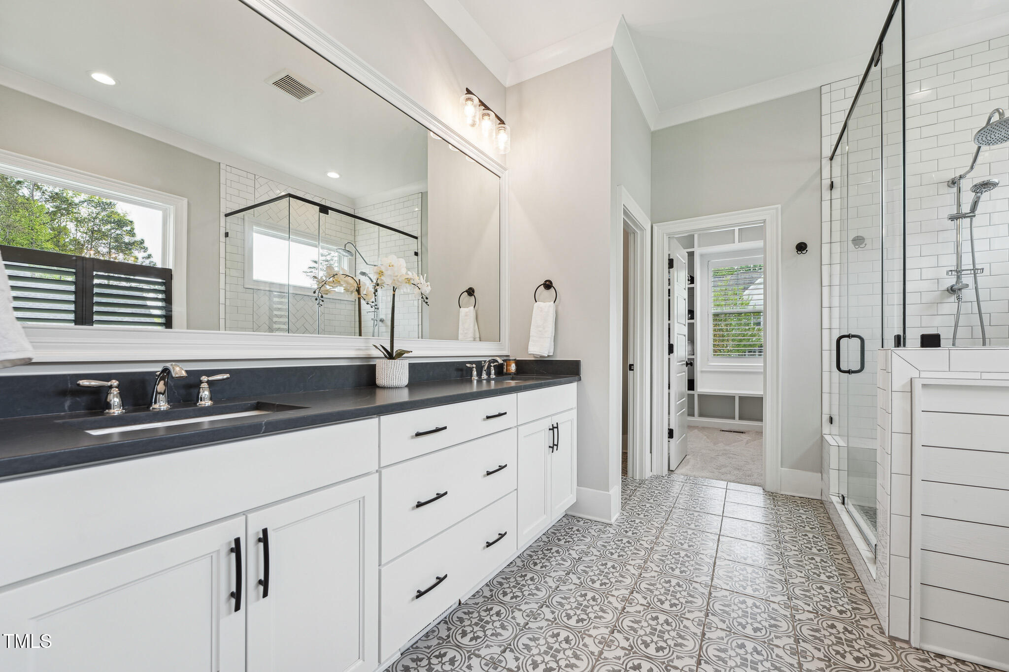 3545 Donlin Drive Wake Forest, NC 27587 - Photo 30 of 62 a bathroom with a double vanity sink a mirror and a shower