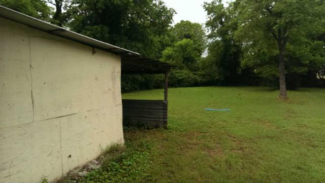 235 West Spring Street Lebanon, TN 37087 - Photo 2 of 20 Huge deep back yard. Plenty of room for kids to play volleyball, etc. A large barn structure (not included in the sf) is shown on the left