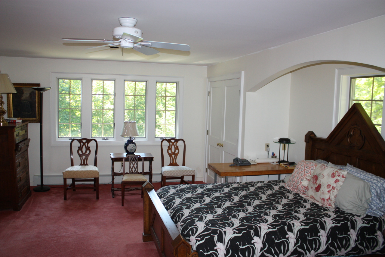 476 Main Road Monterey, MA 01245 - Photo 14 of 18 a bedroom with a bed and a chandelier