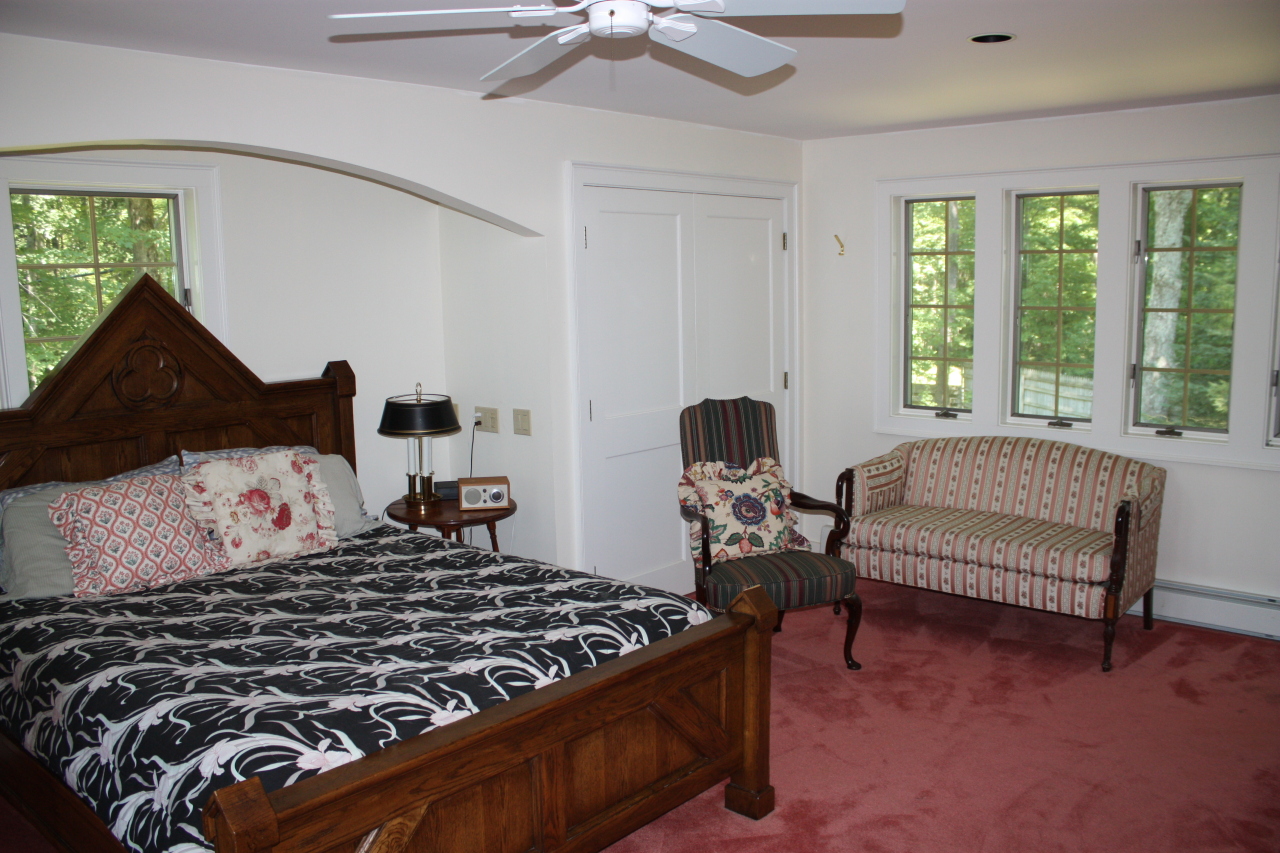 476 Main Road Monterey, MA 01245 - Photo 15 of 18 a bedroom with a bed and a chandelier fan
