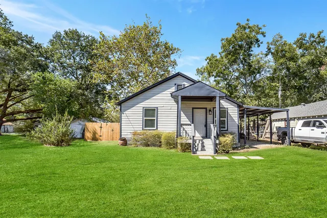 a front view of house with yard and green space