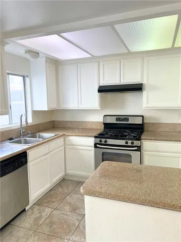 a kitchen with a stove and a sink