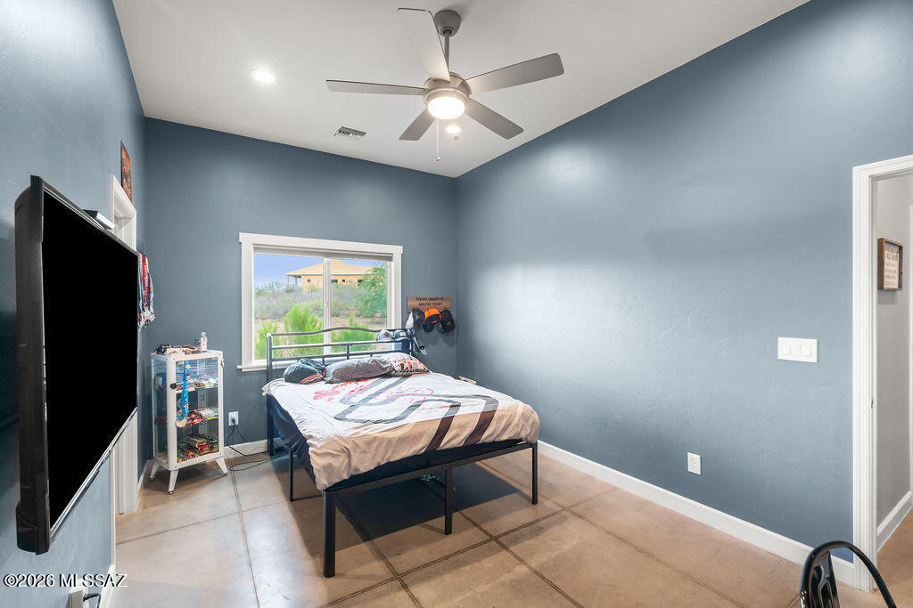 16276 East Empire View Road Vail, AZ 85641 - Photo 20 of 51 a bed room with a bed and a flat screen tv