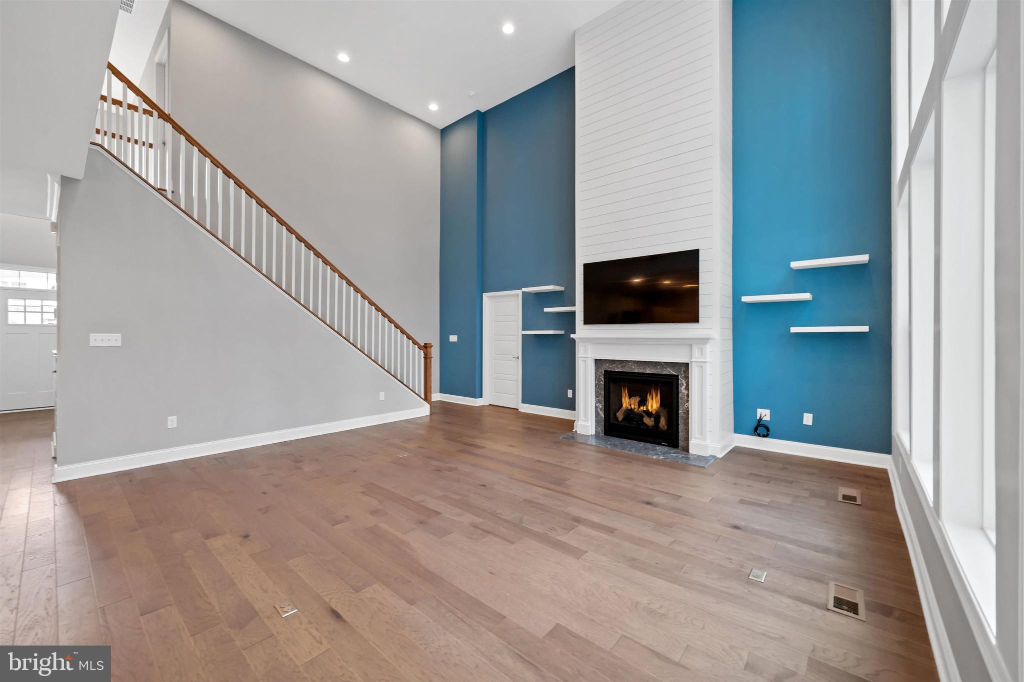 22144 Welches Way Lewes, DE 19958 - Photo 14 of 77 a view of an empty room with wooden floor fireplace and a window
