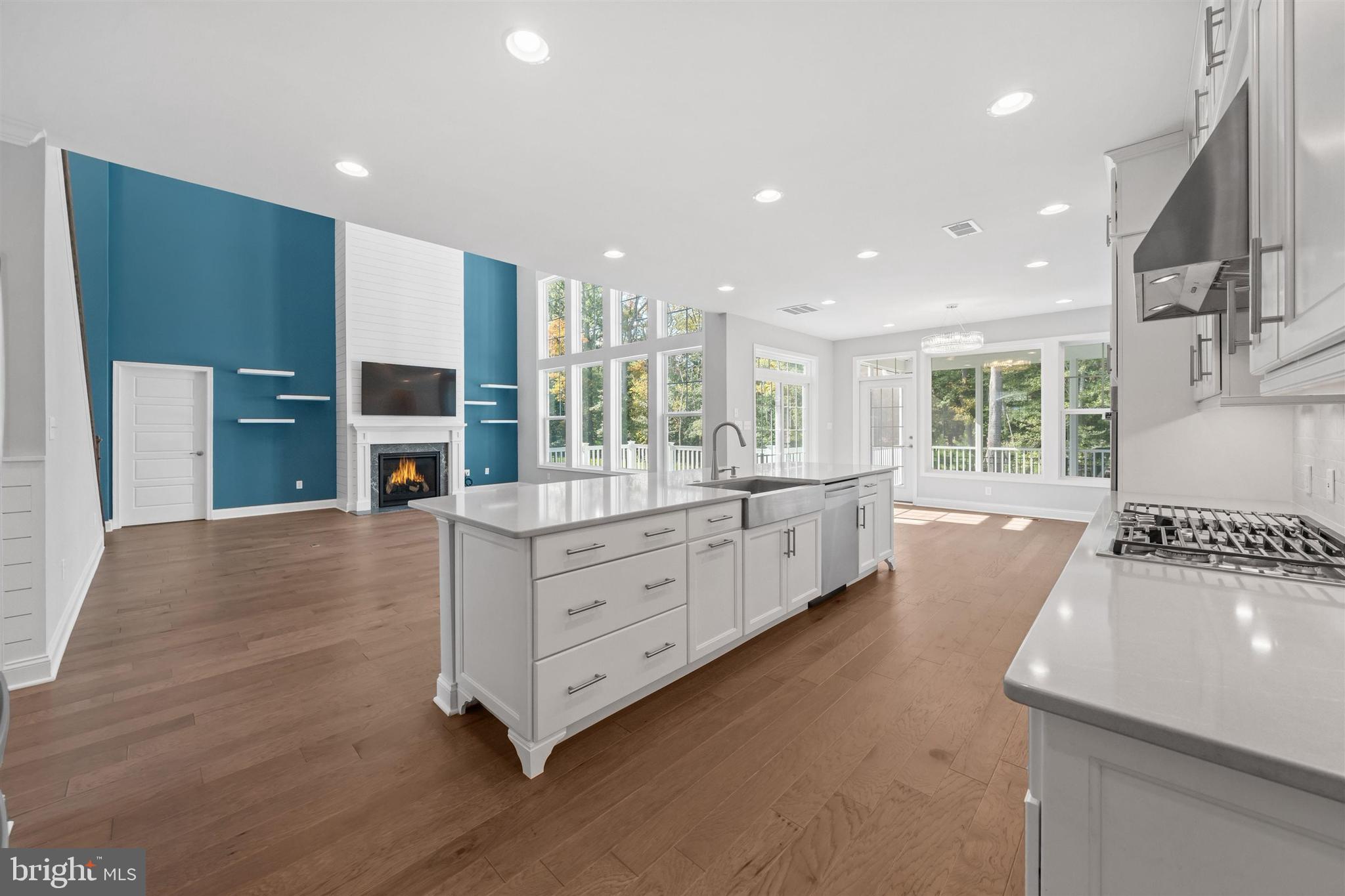 22144 Welches Way Lewes, DE 19958 - Photo 16 of 77 a large kitchen with stainless steel appliances a large counter top a stove and a sink
