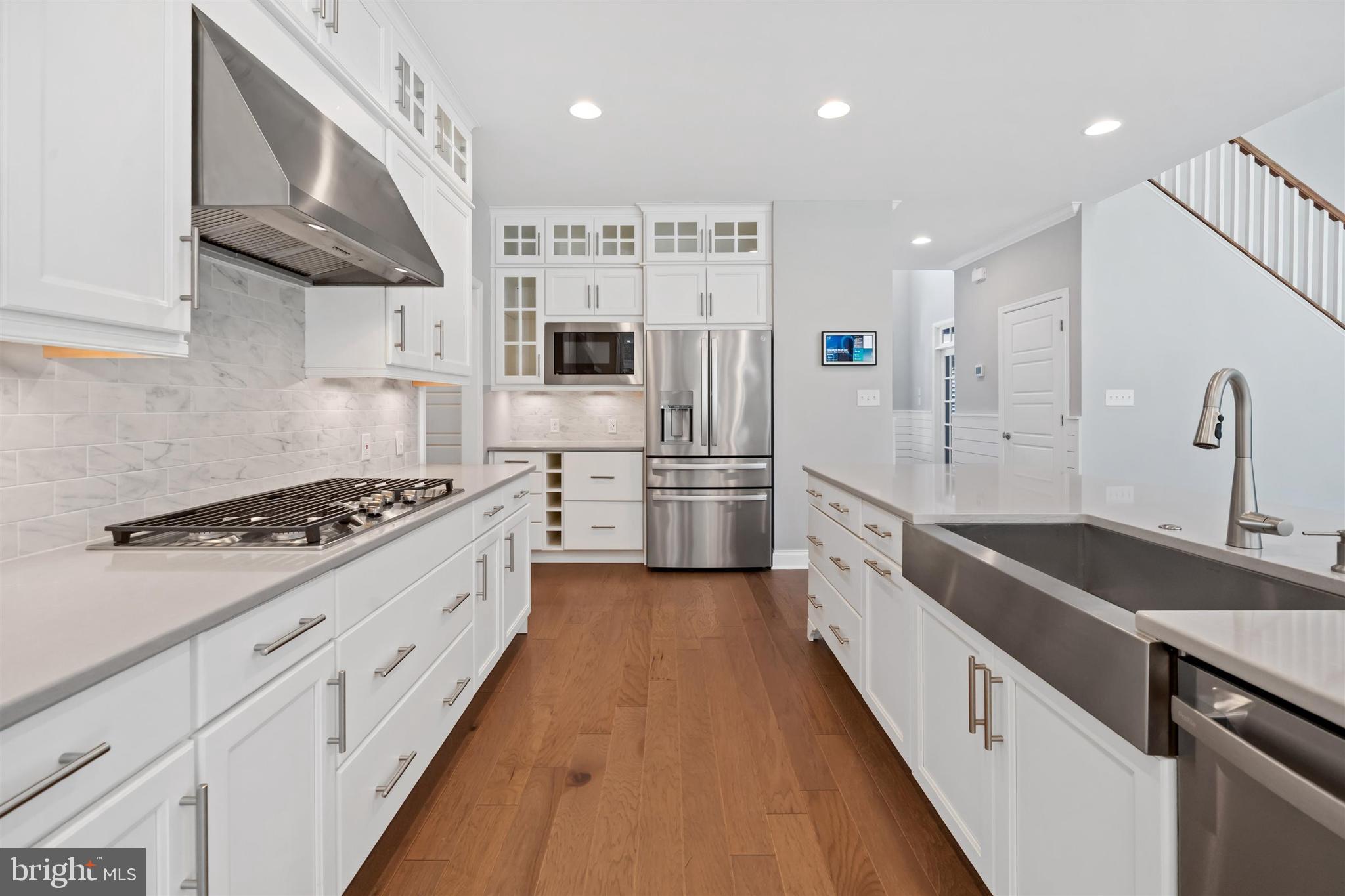 22144 Welches Way Lewes, DE 19958 - Photo 17 of 77 a large kitchen with stainless steel appliances sink a stove and cabinets