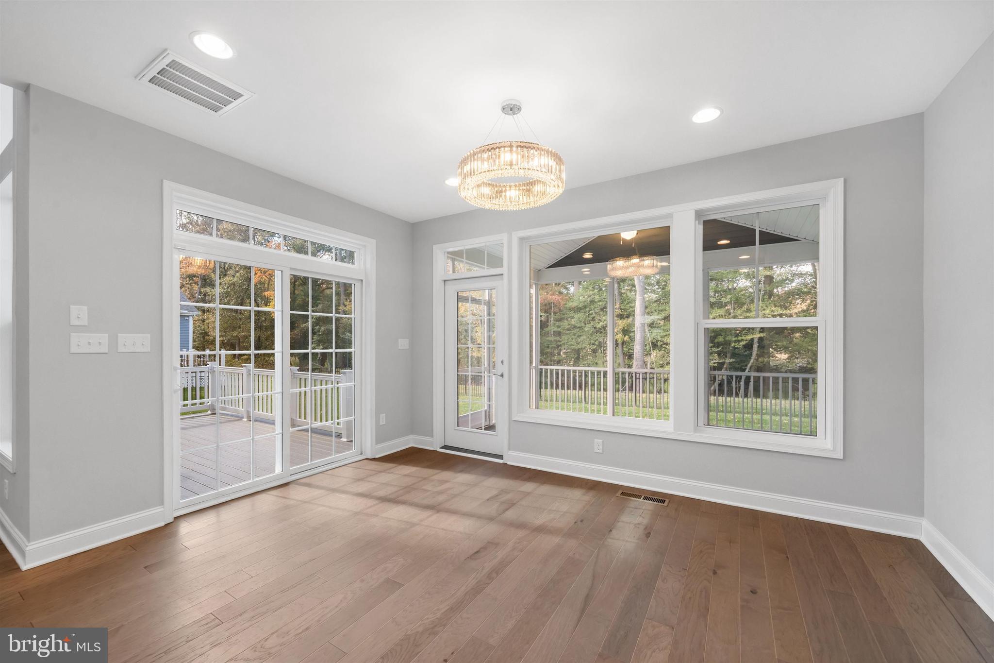 22144 Welches Way Lewes, DE 19958 - Photo 22 of 77 an empty room with wooden floor and windows