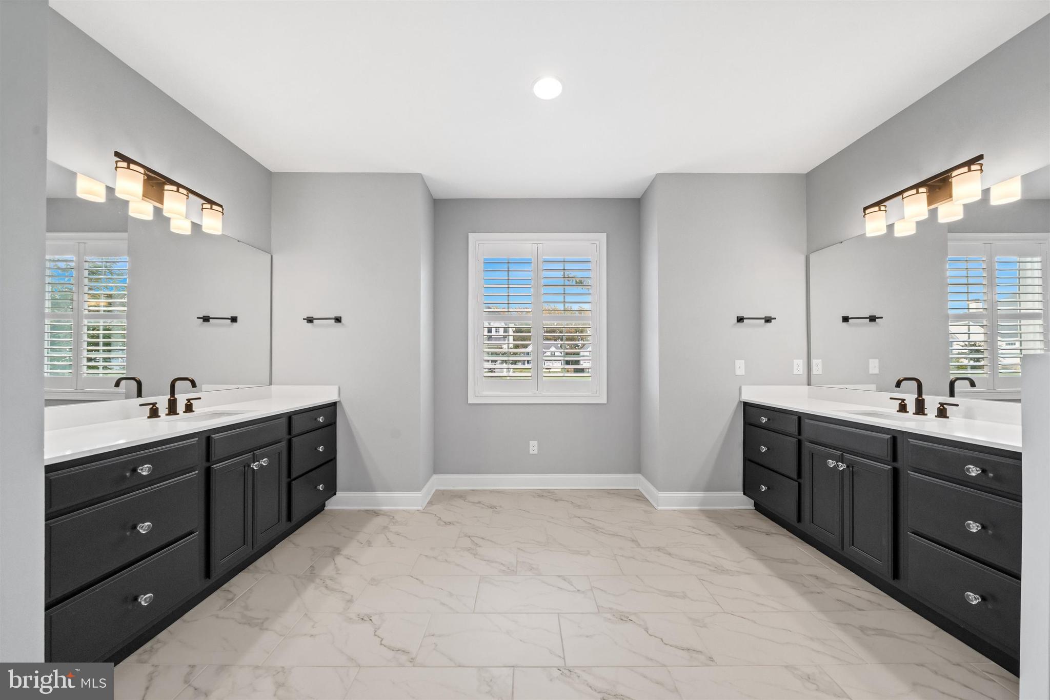 22144 Welches Way Lewes, DE 19958 - Photo 33 of 77 a spacious bathroom with a double vanity sink mirror and window