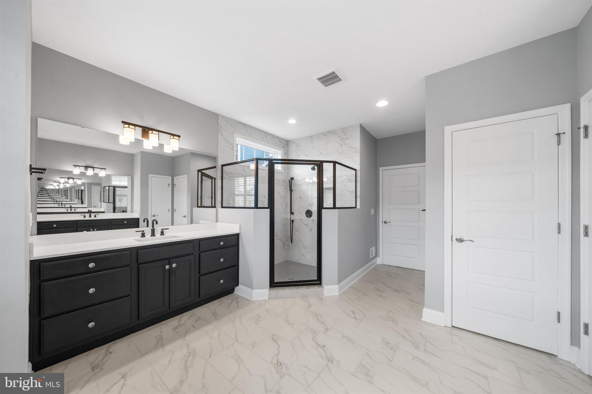22144 Welches Way Lewes, DE 19958 - Photo 34 of 77 a bathroom with a double vanity sink and mirror with shower