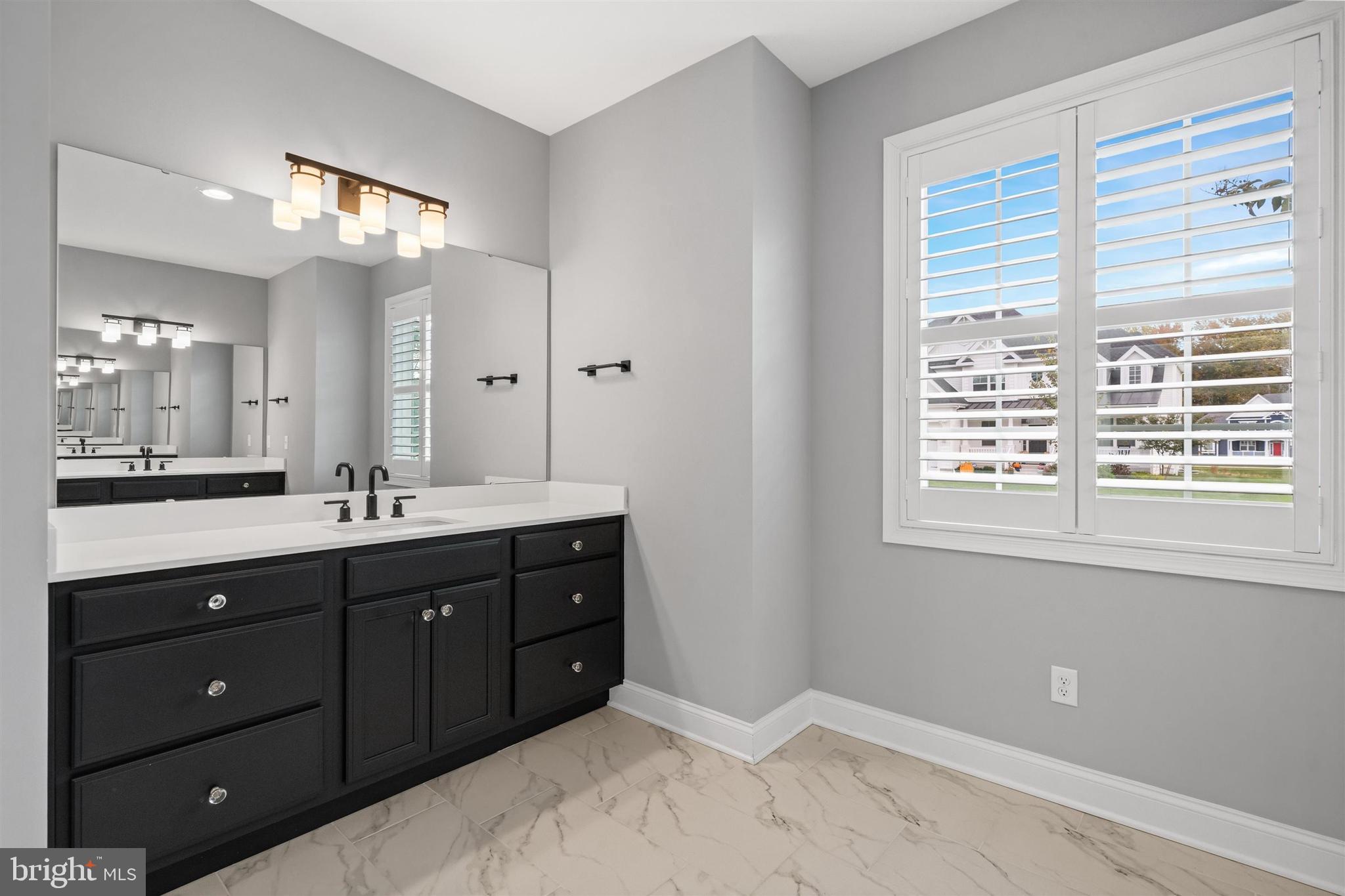 22144 Welches Way Lewes, DE 19958 - Photo 36 of 77 a bathroom with a sink vanity and a mirror