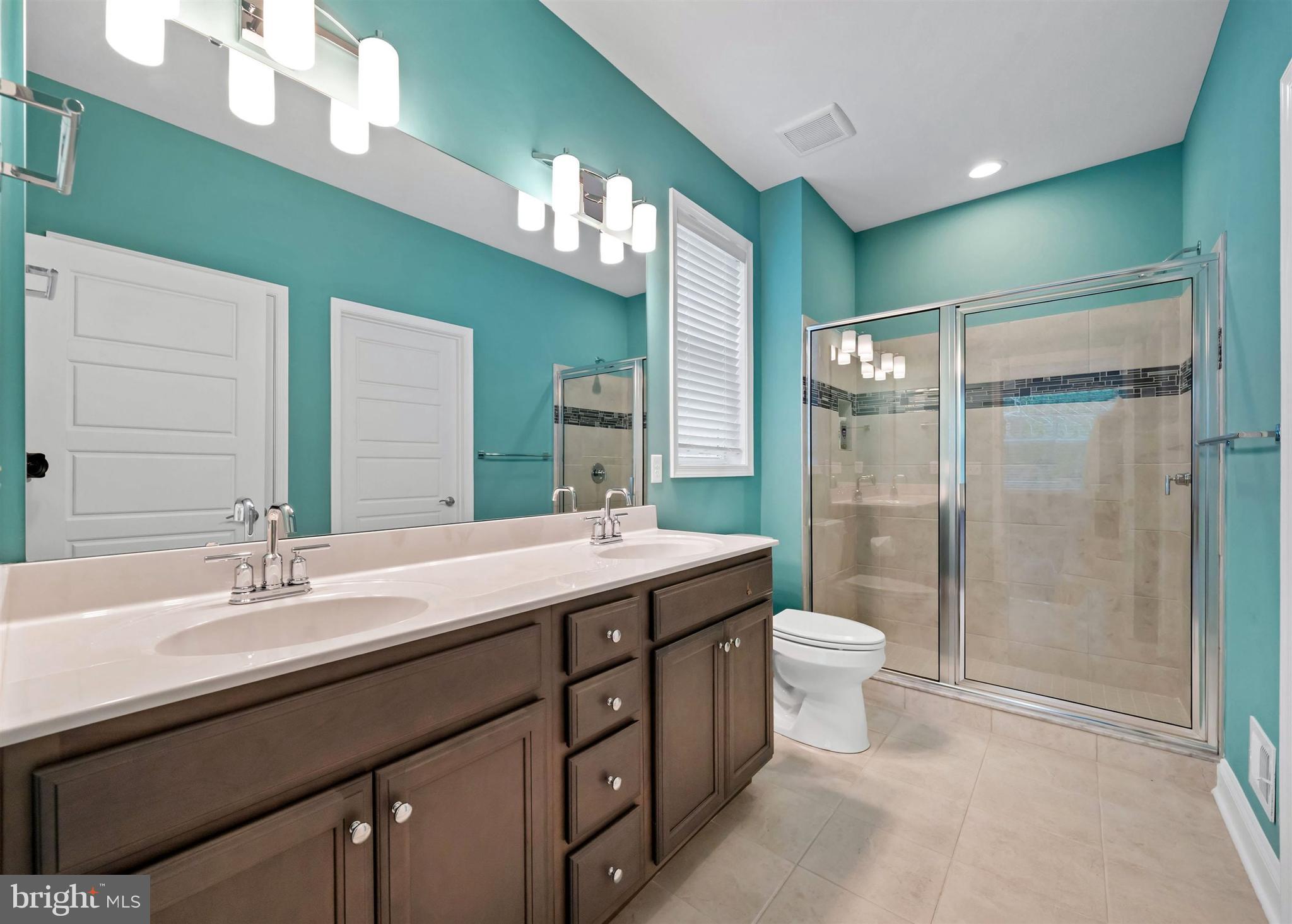 22144 Welches Way Lewes, DE 19958 - Photo 40 of 77 a bathroom with a double vanity sink mirror and toilet