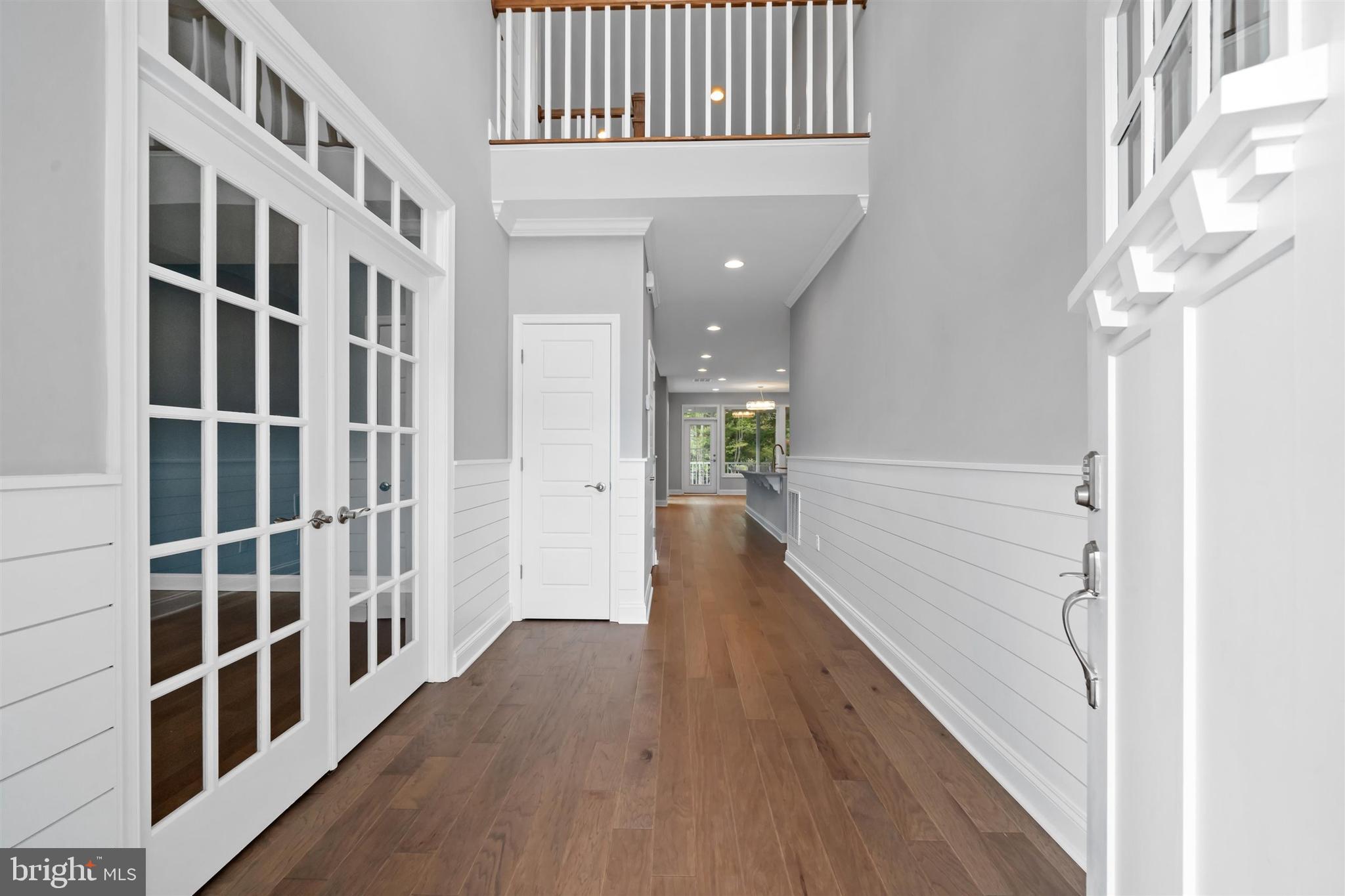 22144 Welches Way Lewes, DE 19958 - Photo 4 of 77 a view of a hallway with wooden floor and entryway