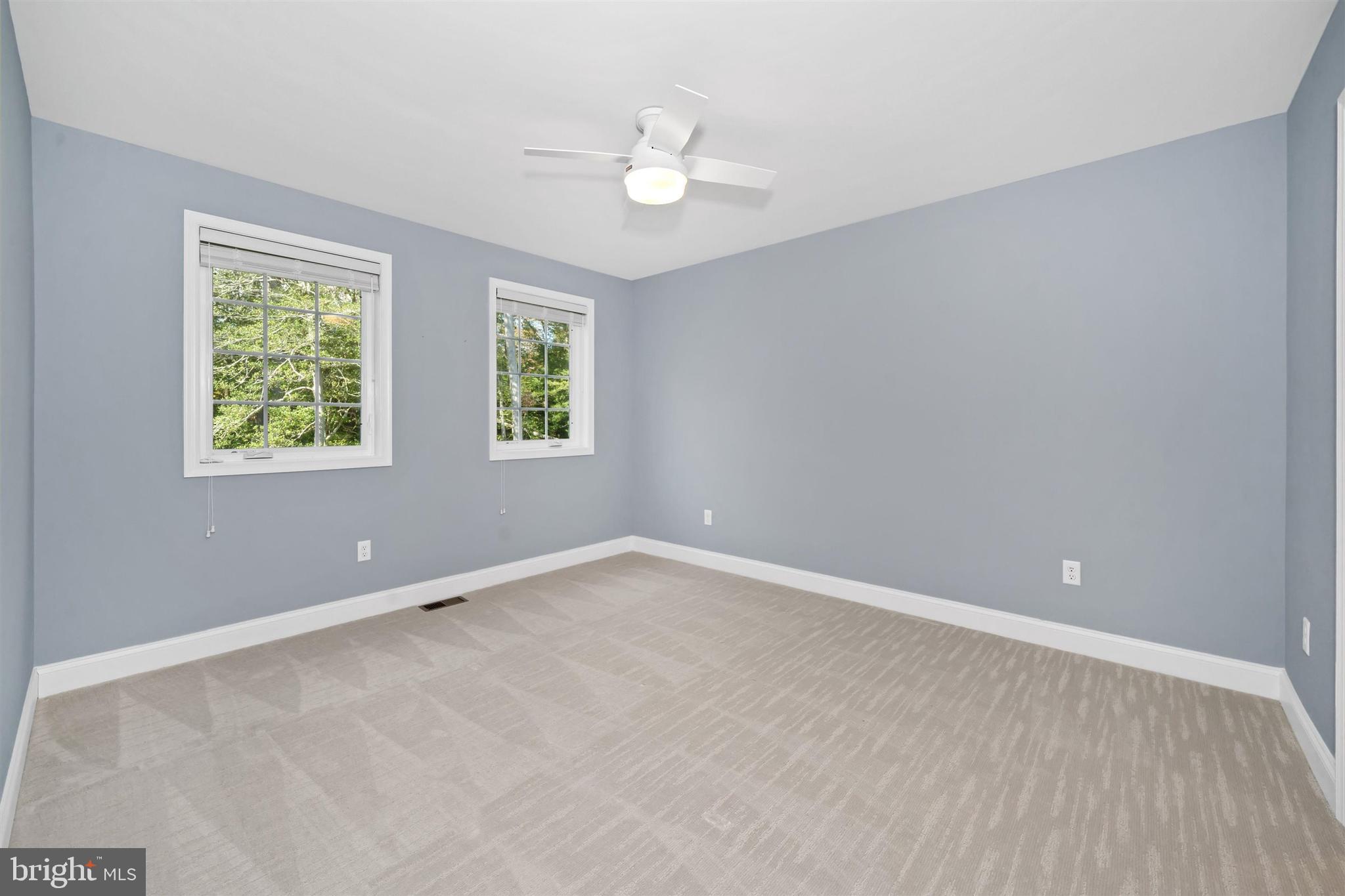 22144 Welches Way Lewes, DE 19958 - Photo 48 of 77 an empty room with windows and ceiling fan
