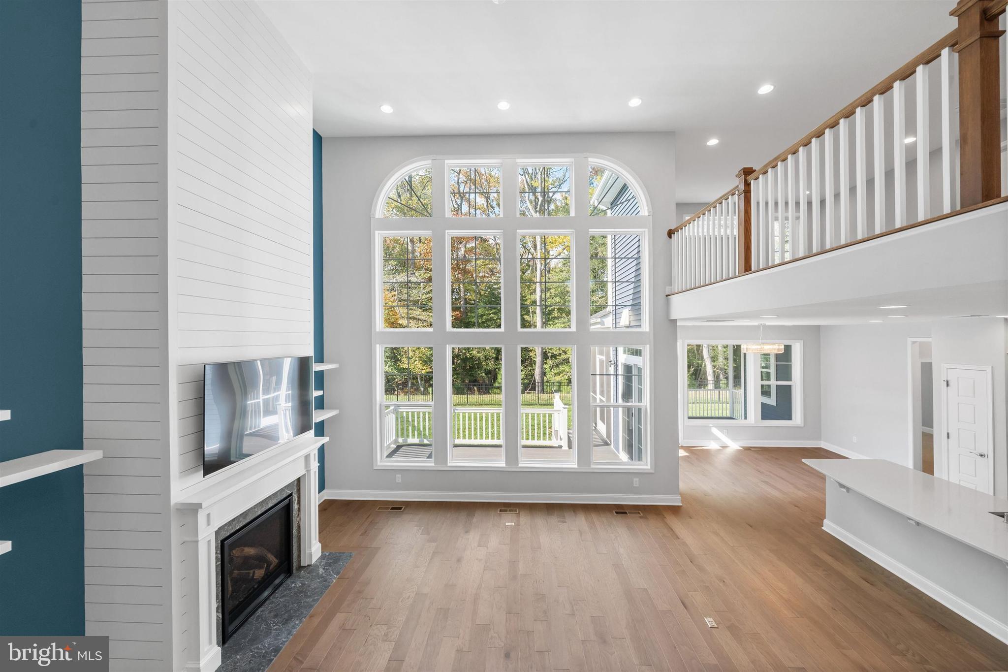 22144 Welches Way Lewes, DE 19958 - Photo 9 of 77 a view of an empty room with a fireplace and a window