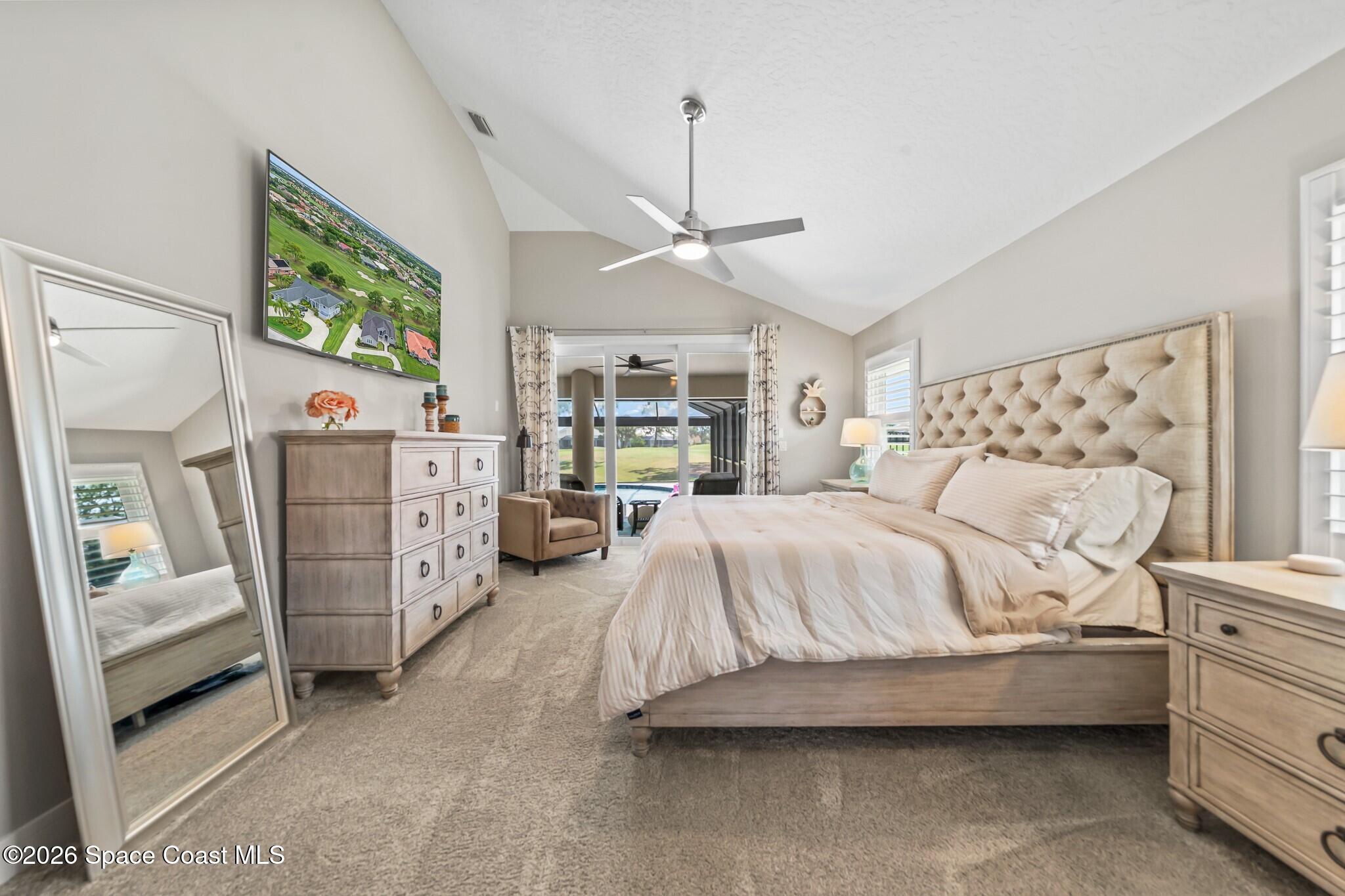 697 Spring Lake Drive Melbourne, FL 32940 - Photo 19 of 45 a spacious bedroom with a bed and a walk in closet
