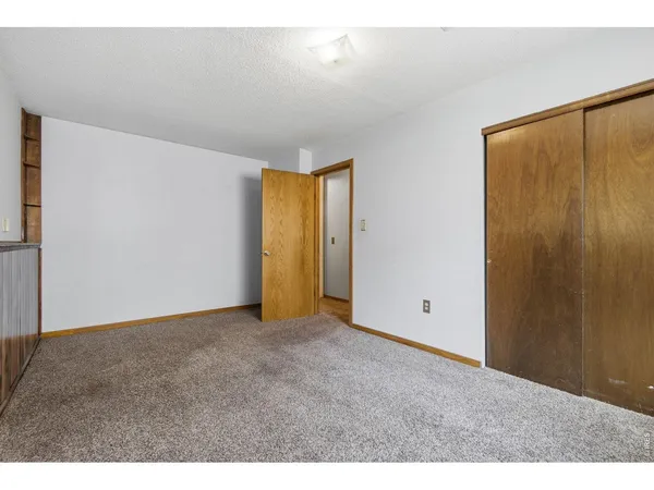 a view of an empty room with closet area