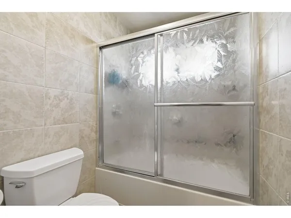 a bathroom with a shower and a toilet