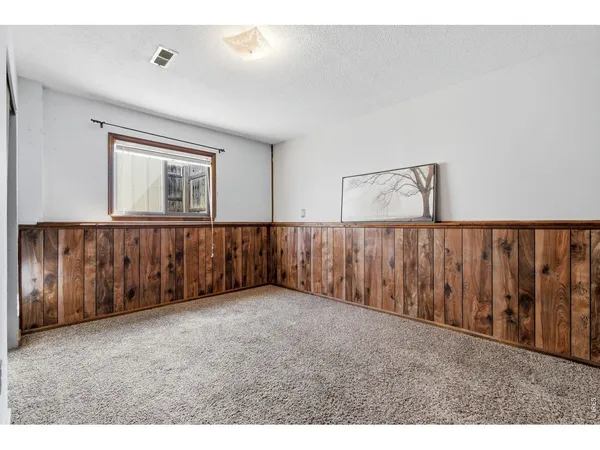 a view of an empty room with wooden walls