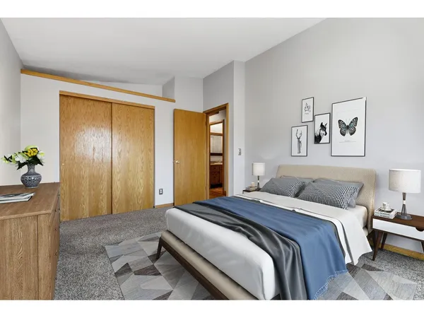 a bedroom with a bed and a painting on the wall