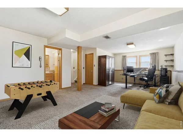 a living room with furniture and white walls