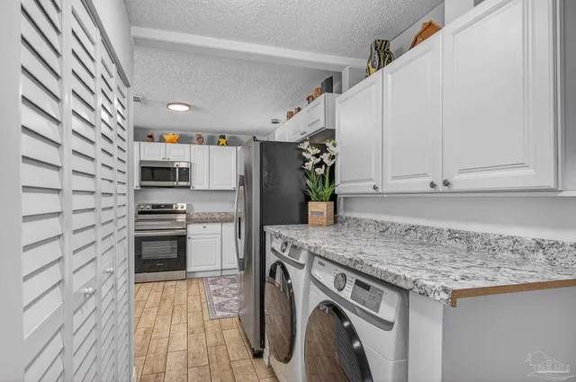 a view of a hallway with washer and dryer