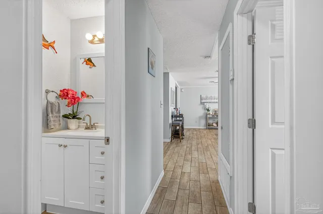 a room with a couch and a lamp on dresser