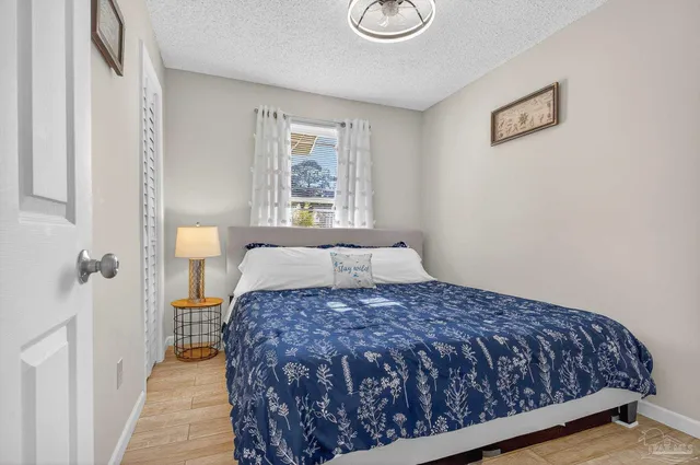 a view of a patio with table and chairs under an umbrella