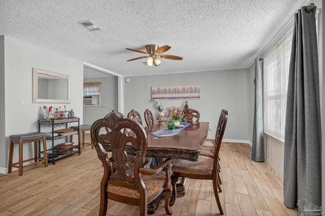 a view of a a dining room with furniture and wooden floor