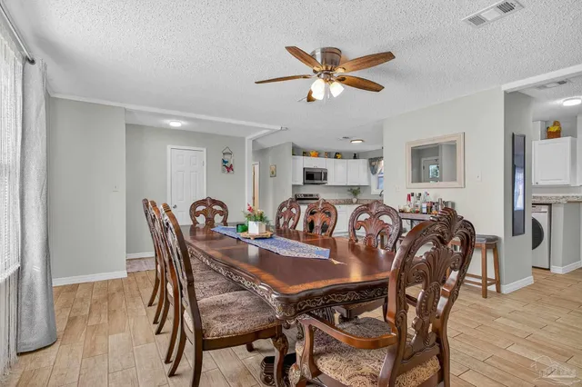 a view of a dining room with furniture and wooden floor