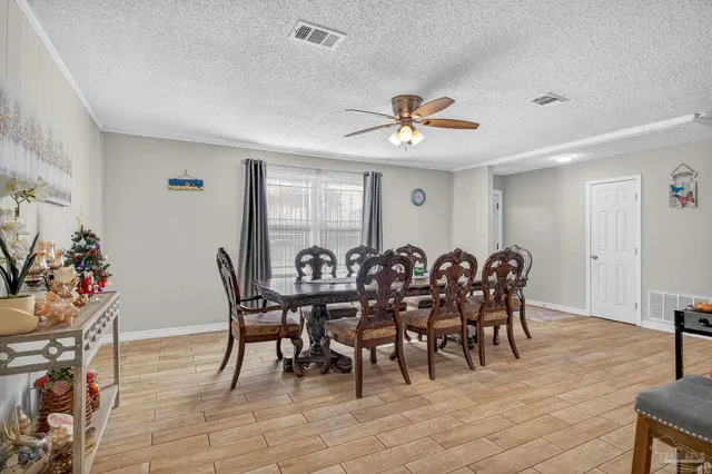 a view of a dining room with furniture and wooden floor